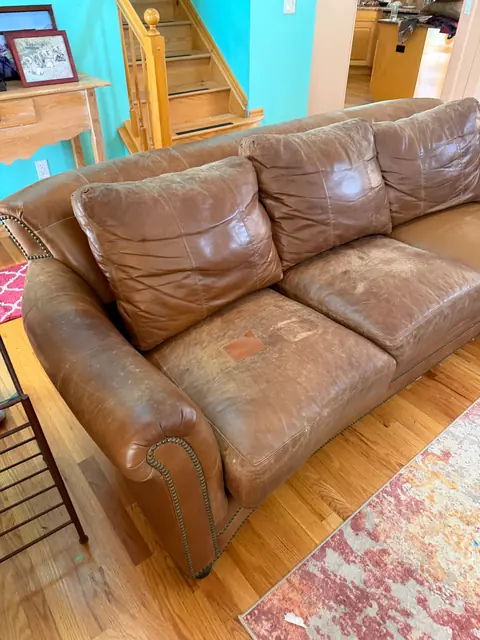 Worn brown leather sofa before restoration in Denver Metro
