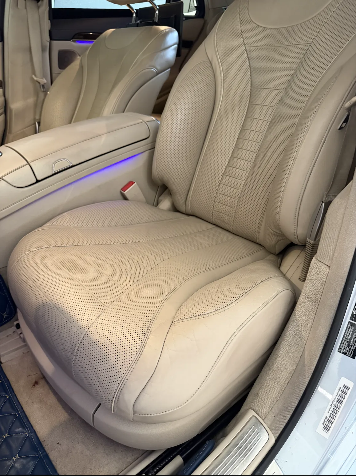 Restored leather car seat after color-matched repair in Denver